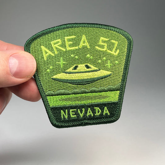 Hand holding the Area 51 Nevada UFO travel patch