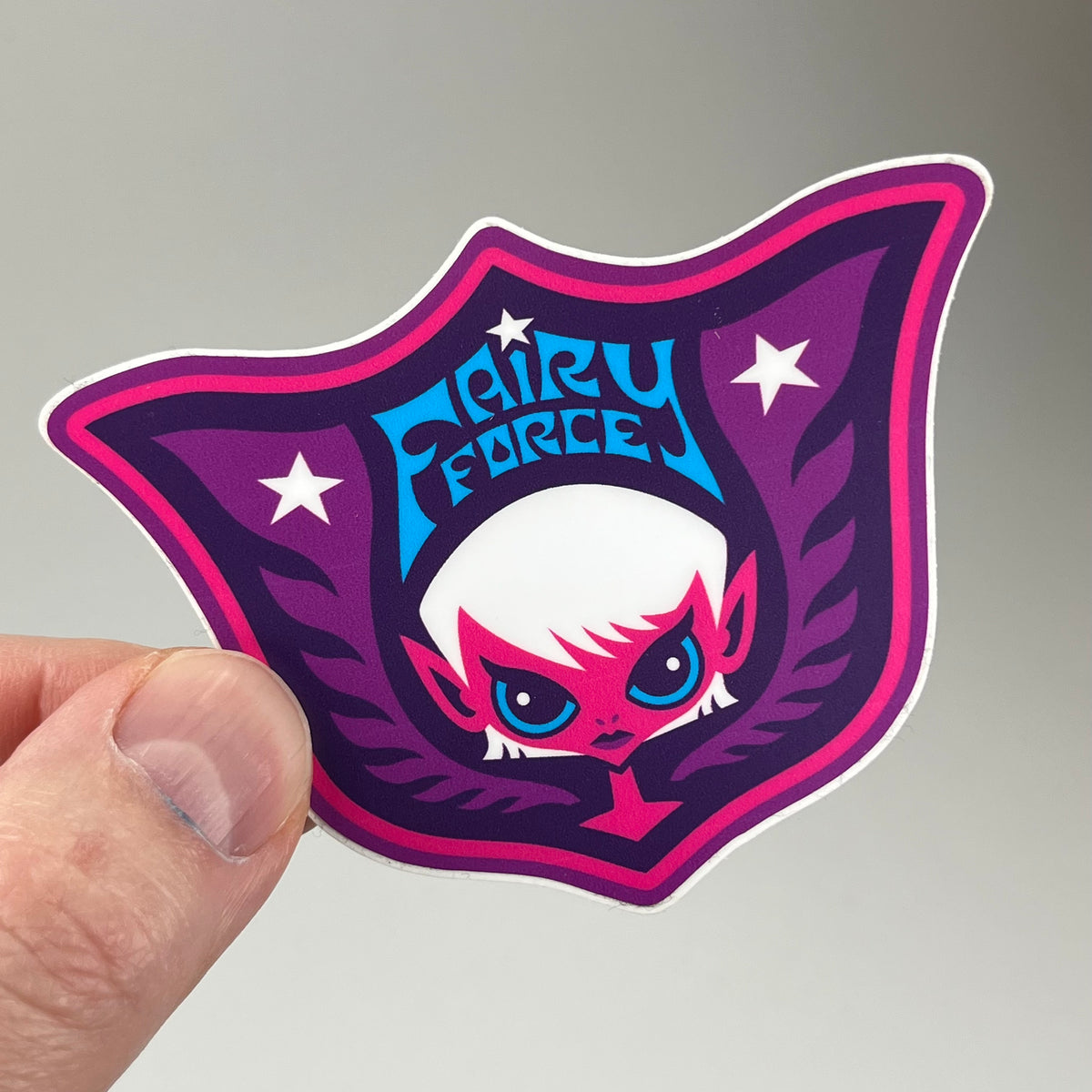 Hand holding the Fairy Force Sticker