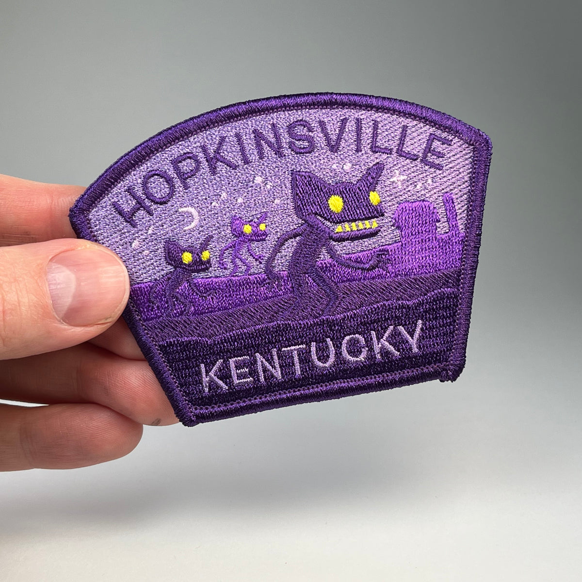 Hand holding the Hopkinsville Kentucky Goblins cryptid travel patch
