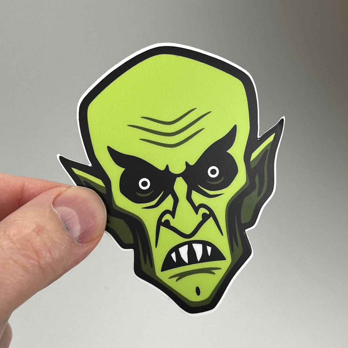 Hand holding the Orlok Nosferatu Head Sticker