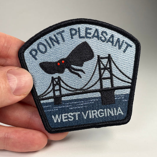 Hand holding the Point Pleasant West Virginia Mothman cryptid travel patch