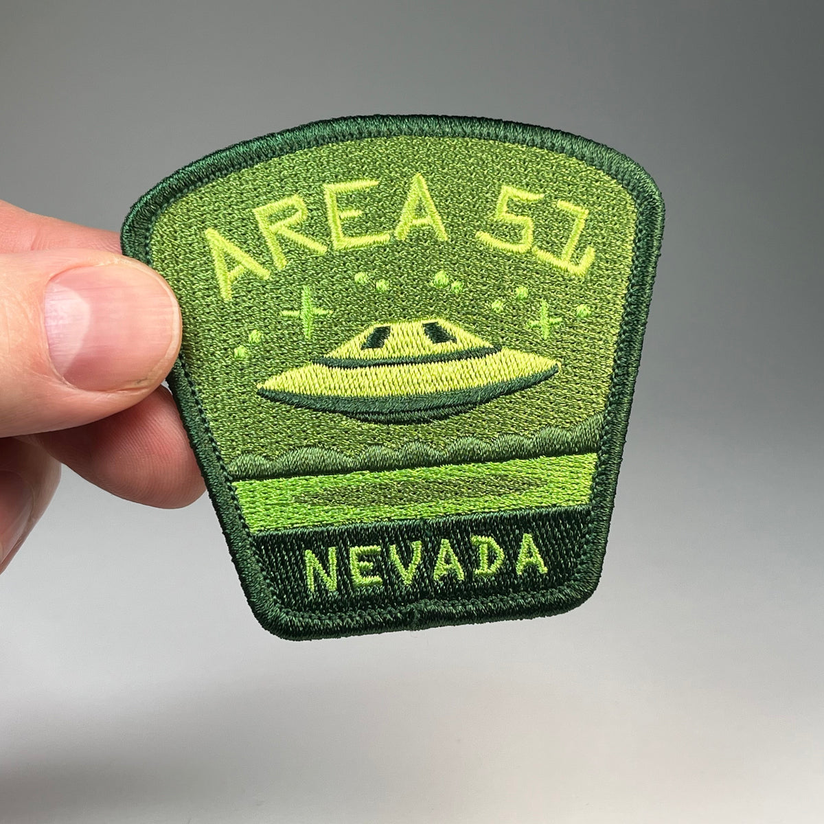 Hand holding the Area 51 Nevada UFO travel patch