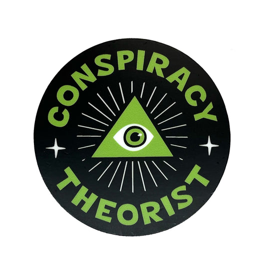 Circular sticker with green text 'CONSPIRACY THEORIST' and a triangle with an eye symbol on a black background.
