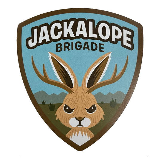 Logo of the Jackalope Brigade with a cute angry jackalope illustration in military shield emblem design. 