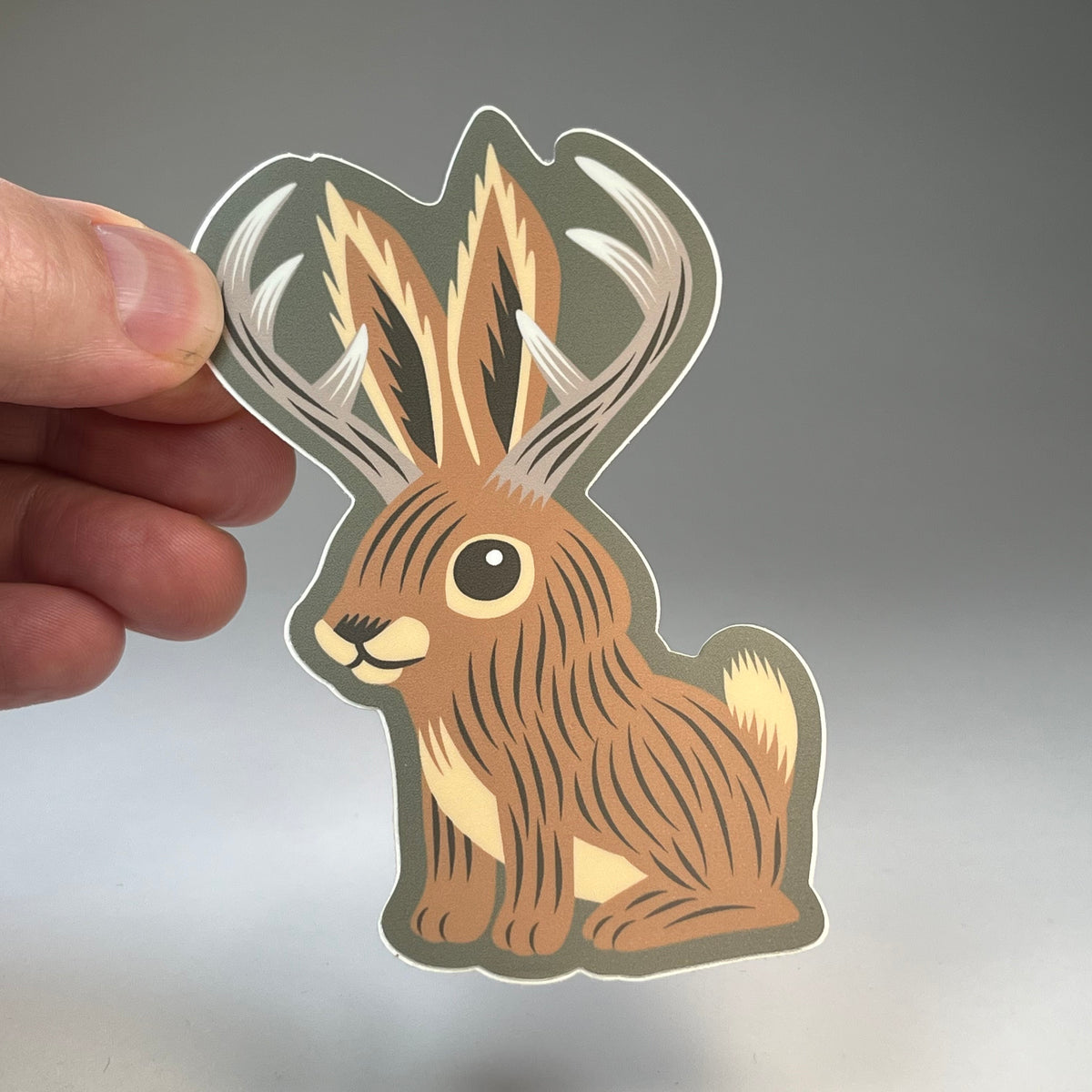 Hand holding the Jackalope Cute cryptid sticker