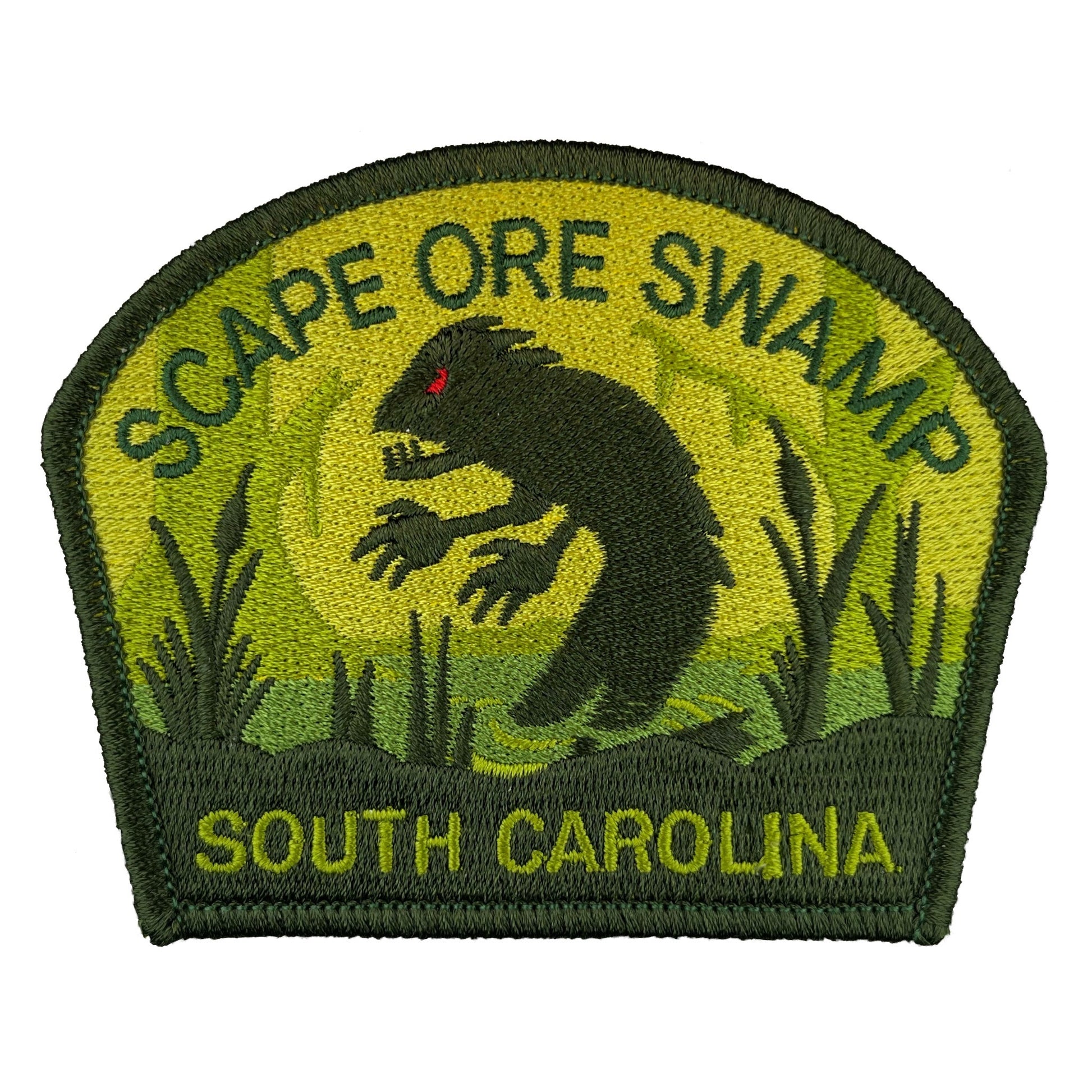 Embroidered patch with a Lizardman cryptid creature and text 'Scape Ore Swamp, South Carolina' on a green background