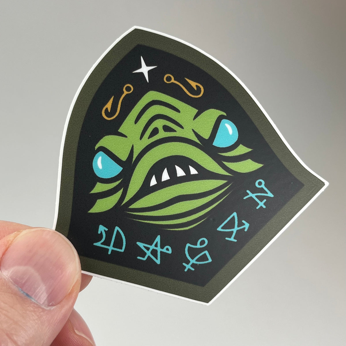 Hand holding the Sons Of Dagon Sticker