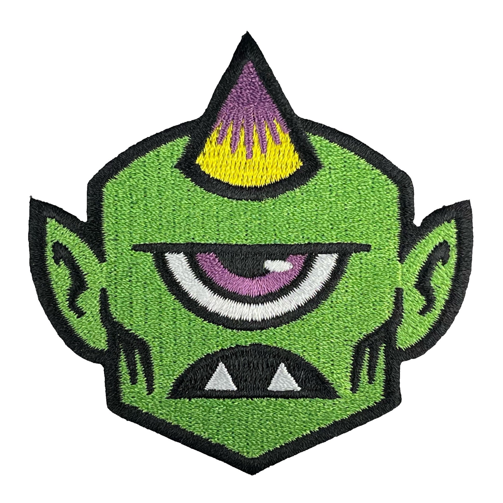 Green Monsterologist cyclops head patch with yellow and purple horn on a white background