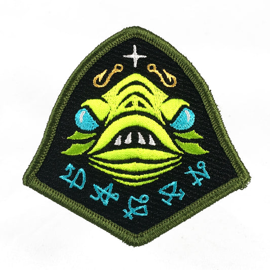 Embroidered patch with a green Lovecraft Dagon fish god face design on a black background